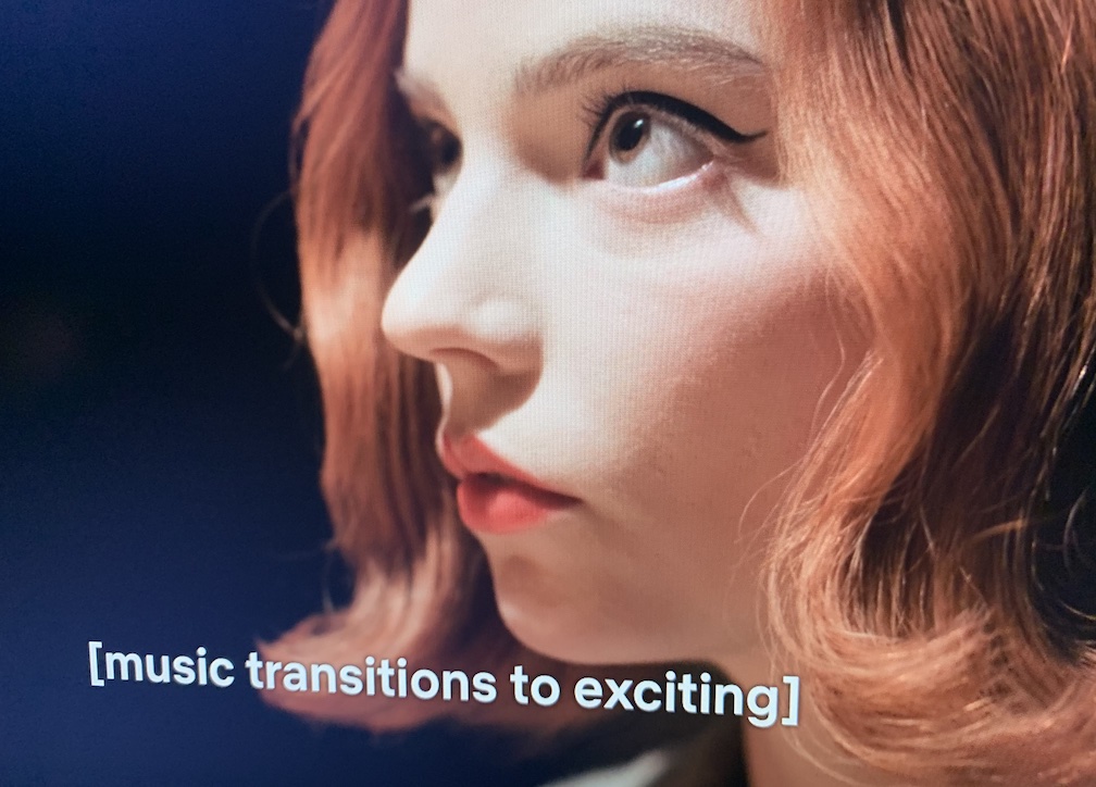Subtitles saying “[music transitions to exciting]”