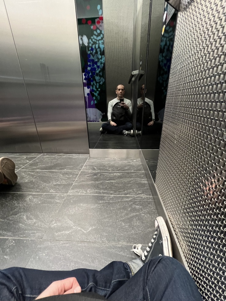Me sat on the floor of a lift