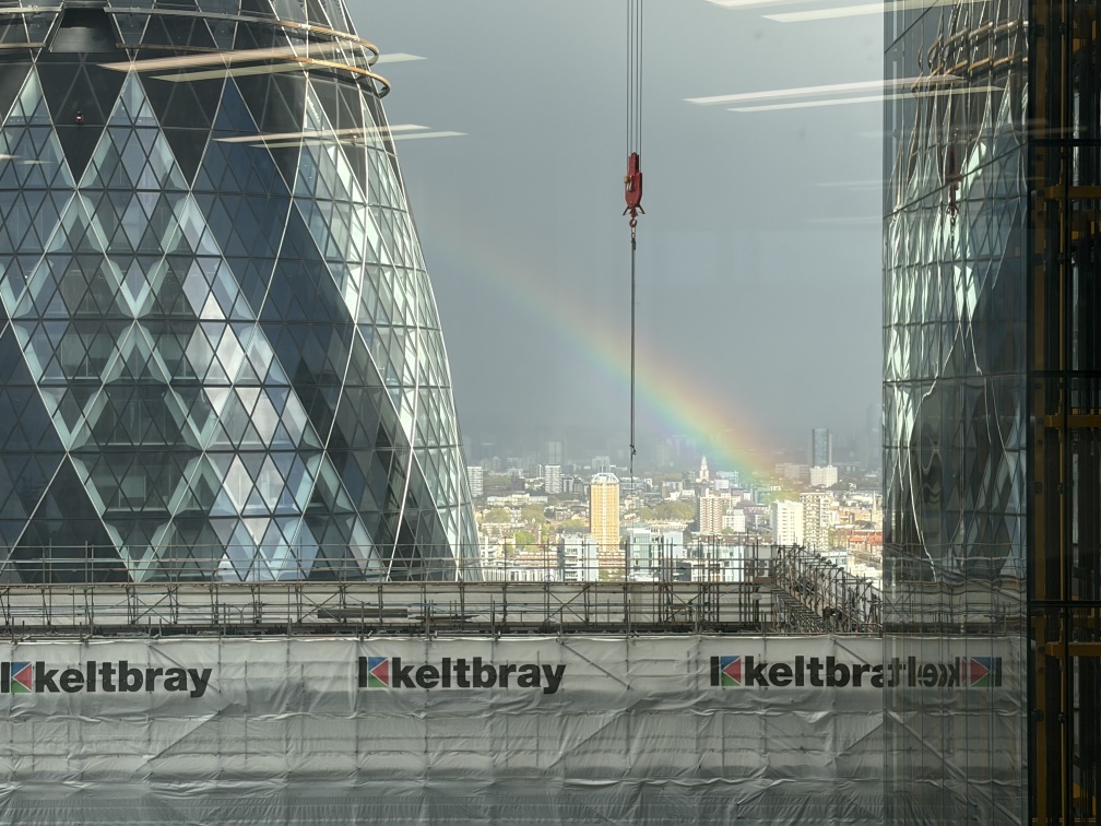 A rainbow visible between the Gherkin, the Cheesegrater and the partially demolished St Helen’s