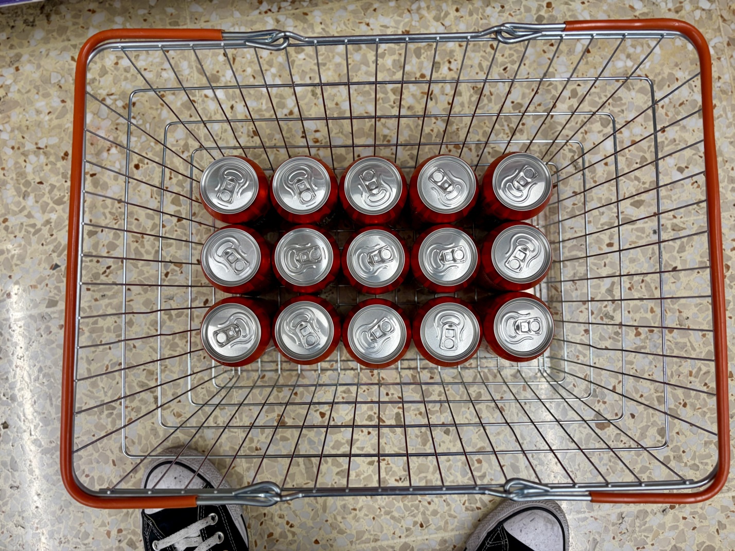 A supermarket basket filled with cans