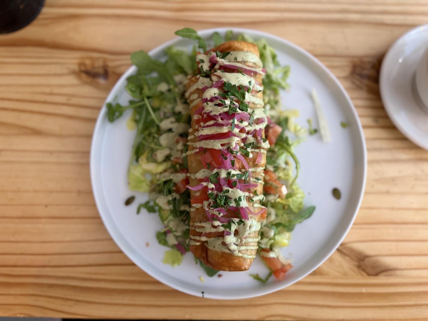 A “chickpea caesar chimichanga” at Black Cat Café