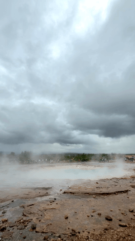 Strokkur erupting and splashing the camera with hot water