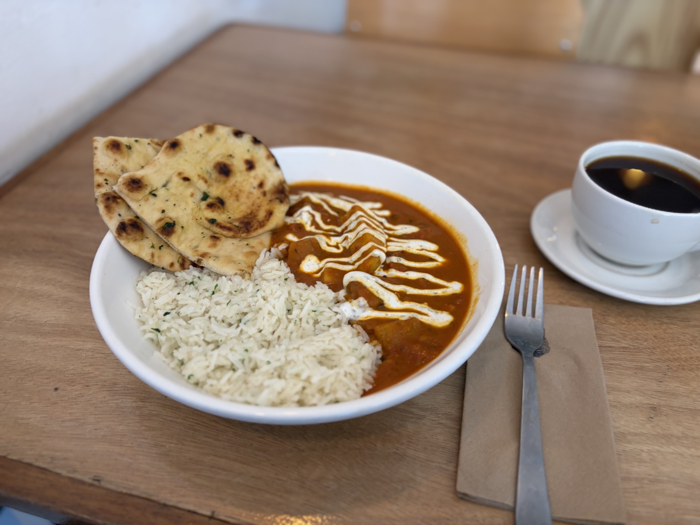 A jackfruit and plantain curry with rice and naan